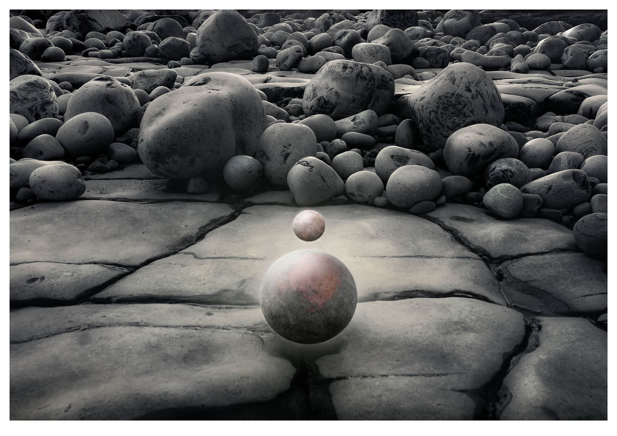 Jurassic boulders form background for small planet floating above larger one in surreal fantasy universe photograph